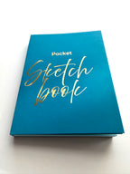 Blue sketchbook with gold text on a white background