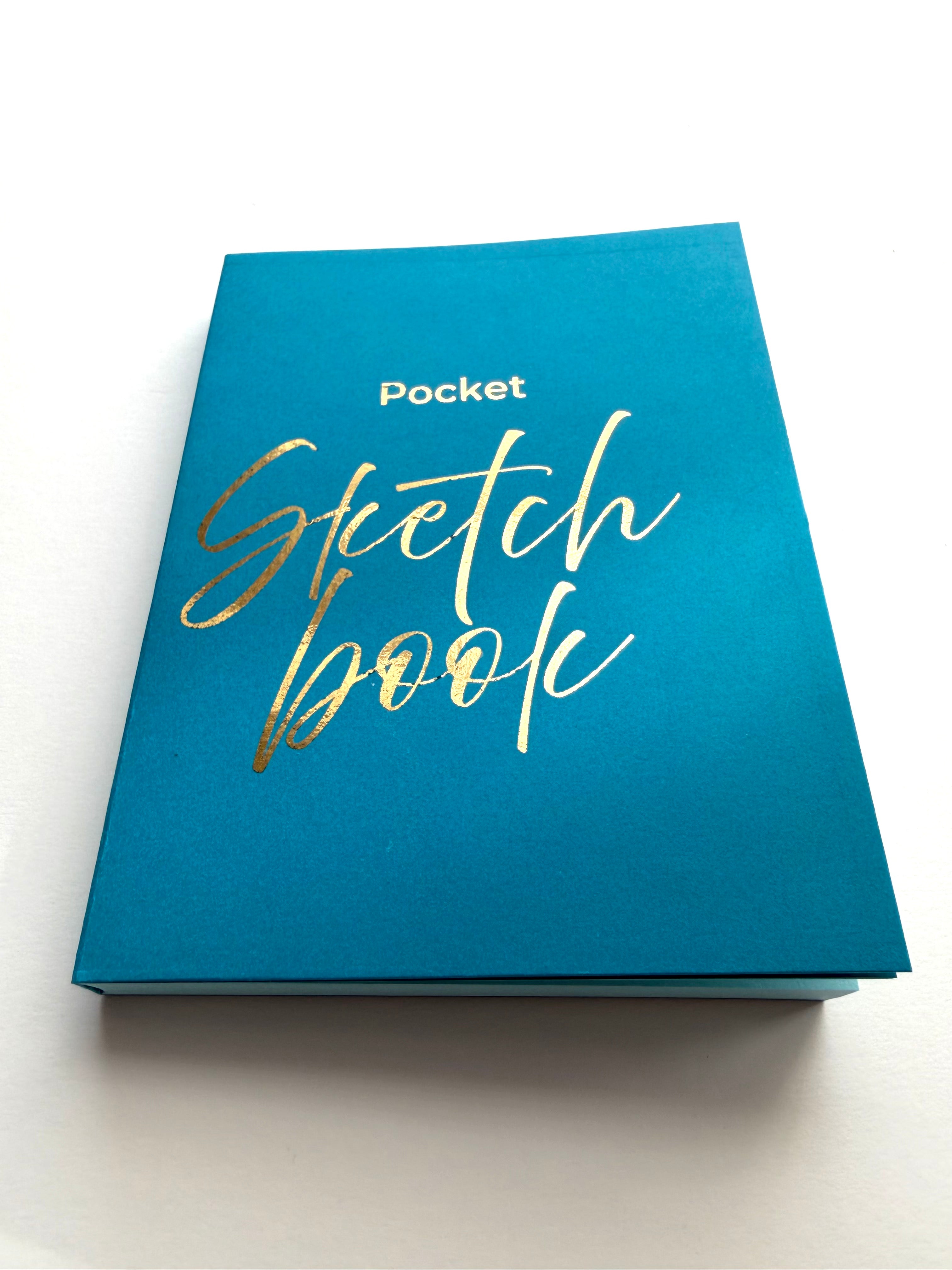 Blue sketchbook with gold text on a white background