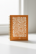 Joshua Tree Notebook side view showing gold spiral binding and hard covers